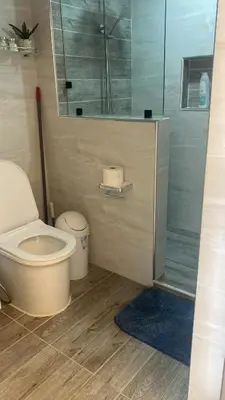 a bathroom with a toilet and a glass shower at Mar & Relax in Santo Domingo