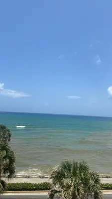 a view of a beach with palm trees and the ocean at Mar & Relax in Santo Domingo