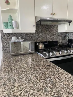 a kitchen counter with a microwave and a stove at Hermoso Aparta- Estudio Frente al Mar in Santo Domingo