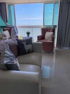 a living room with a couch and a chair at Hermoso Aparta- Estudio Frente al Mar in Santo Domingo