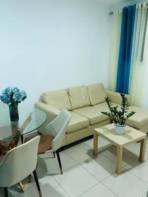 a living room with a couch and a table at Apartamento Acogedor in San Felipe de Puerto Plata