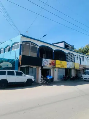 a white truck parked in front of a building at Apartamento Acogedor in San Felipe de Puerto Plata