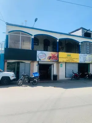 a building with motorcycles parked in front of it at Apartamento Acogedor in San Felipe de Puerto Plata