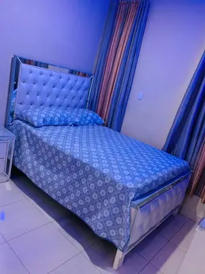 a bedroom with a bed with a blue comforter at Apartamento Mariela 2 in San Felipe de Puerto Plata