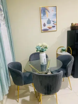 a glass table and chairs with a vase on top at Apartamento Mariela 2 in San Felipe de Puerto Plata