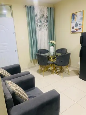 a living room with a table and chairs at Apartamento Mariela 2 in San Felipe de Puerto Plata