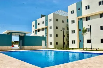 a swimming pool in front of two buildings at Disfruta, te lo mereces in La Romana