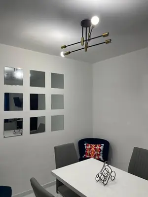 a dining room with a white table and chairs at Disfruta, te lo mereces in La Romana