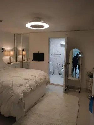 a bedroom with a bed and a person in a mirror at Luxury Apartment Hot Water,AC,WiFi,PS3 in San Felipe de Puerto Plata