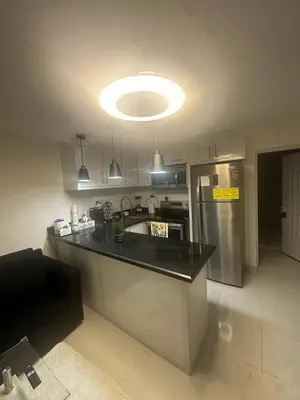 a kitchen with a counter top and a refrigerator at Luxury Apartment Hot Water,AC,WiFi,PS3 in San Felipe de Puerto Plata