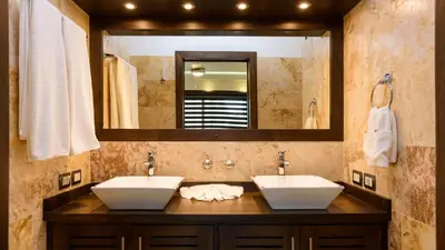 a bathroom with two sinks and a large mirror at Aligio Apart-hotel & Spa - Las Terrenas in Las Terrenas