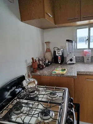 a kitchen with a stove top oven in a kitchen at Higüey City Home in Higuey