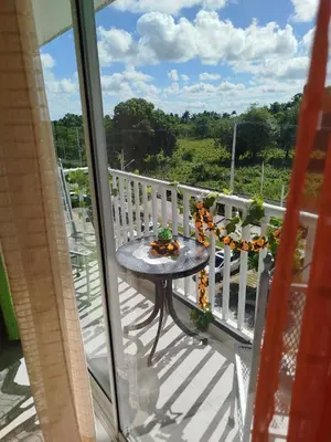 a patio table on a balcony with a view at Higüey City Home in Higuey