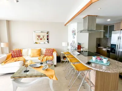 a kitchen and living room with a couch and a table at Marbella, Juan Dolio, Republica Dominicana in Juan Pedro