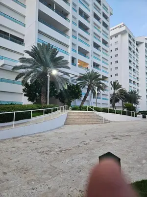a person standing in front of a tall building at Marbella, Juan Dolio, Republica Dominicana in Juan Pedro