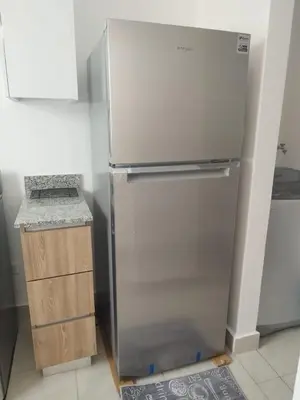 a stainless steel refrigerator in a kitchen next to a counter at santiago de los caballeros hipanoamericana in Santiago de los Caballeros