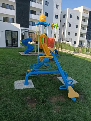 a playground in a park with a slide at santiago de los caballeros hipanoamericana in Santiago de los Caballeros