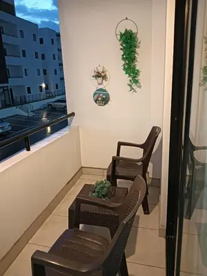 two chairs and a table on a balcony at santiago de los caballeros hipanoamericana in Santiago de los Caballeros