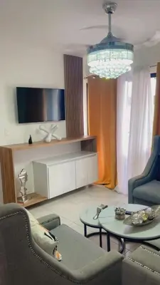 a living room with a couch and a table at santiago de los caballeros hipanoamericana in Santiago de los Caballeros
