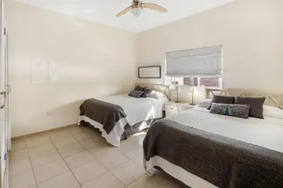 a bedroom with two beds and a ceiling fan at Ocean front 2bdrm-2bath at Ocean Point 1 - Kitebeach Cabarete in Cabarete