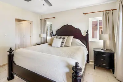 a bedroom with a large bed and two lamps at Ocean front 2bdrm-2bath at Ocean Point 1 - Kitebeach Cabarete in Cabarete