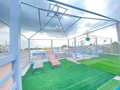 a balcony with two chairs on a baseball field at 6B Santiago Harmonic Apt Especially For You in Santiago de los Caballeros