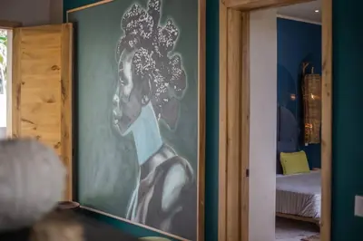 a painting of a woman on a wall in a room at Coconut Beach House Playa Bonita Las terrenas Dominican Republic in Las Terrenas