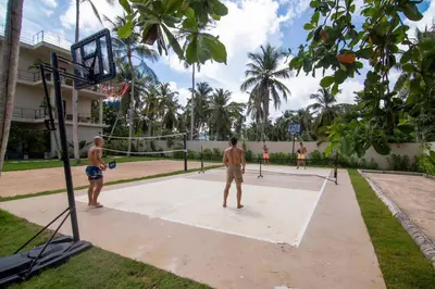 two men playing basketball on a basketball court at Coconut Beach House Playa Bonita Las terrenas Dominican Republic in Las Terrenas