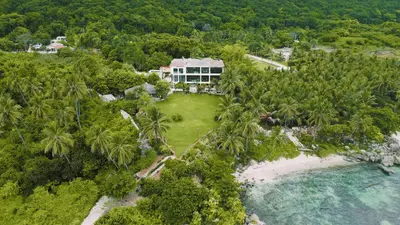 an aerial view of a resort with palm trees at Villa Tesoros del Mar - Luxury Beachfront Villa with Natural Pool, Jacuzzi, Mountain Views, Yoga, BBQ, Wi-Fi, Pet & Family Friendly, Barahona Adventures in El Arroyo
