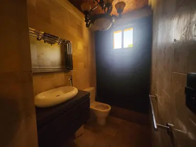 a bathroom with a sink and a toilet and a window at Villa Tesoros del Mar - Luxury Beachfront Villa with Natural Pool, Jacuzzi, Mountain Views, Yoga, BBQ, Wi-Fi, Pet & Family Friendly, Barahona Adventures in El Arroyo