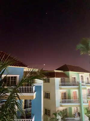 a view of a building at night at Palm Suites E-6-two-level apartment with a view of the pool in Punta Cana