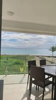 a patio with a table and chairs and a view of the ocean at B3 beautiful ocean view penthouse - Ocean Front in Cabarete