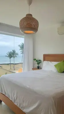 a bedroom with a bed with a view of the beach at B3 beautiful ocean view penthouse - Ocean Front in Cabarete
