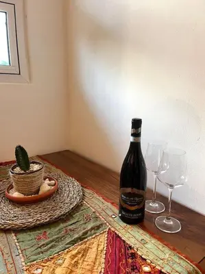 a bottle of wine and two glasses on a table at Cozy Apartment in Las Galeras in Las Galeras