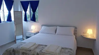 a bedroom with a bed with two towels on it at apart Jacaranda Bayahibe in Bayahibe