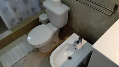 a bathroom with a white toilet and a sink at apart Jacaranda Bayahibe in Bayahibe