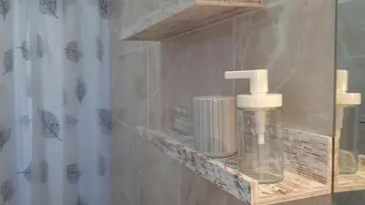 a bathroom with a soap dispenser on a shelf at apart Jacaranda Bayahibe in Bayahibe