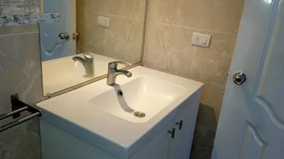a bathroom with a sink and a mirror at apart Jacaranda Bayahibe in Bayahibe