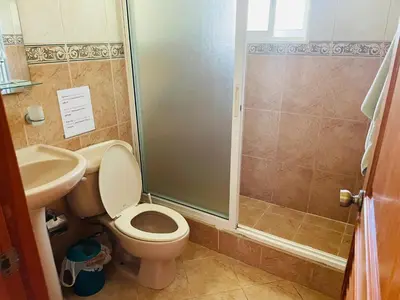 a bathroom with a shower and a toilet and a sink at Luxurious Villa in Sosúa + Pool in Sosúa
