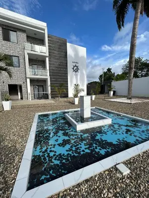 a swimming pool in front of a building at Level suites VIP in Sosúa
