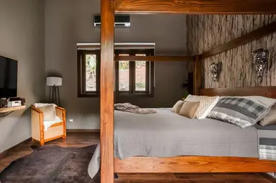 a bedroom with a wooden bunk bed and a television at Villa de Estilo Japones in Jarabacoa