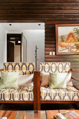 a living room with two couches and a mirror at Villa de Estilo Japones in Jarabacoa