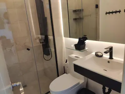 a bathroom with a toilet and a sink and a shower at Cana Rock Condos in Punta Cana