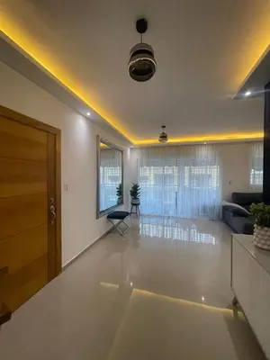 an empty living room with a door and a living room at Apartamento completo con jacuzzi y gazebo in Santo Domingo