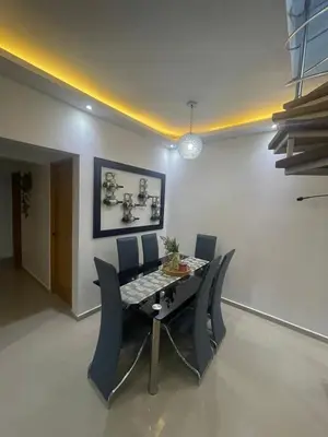a dining room with a table and chairs at Apartamento completo con jacuzzi y gazebo in Santo Domingo