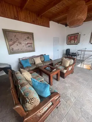 a living room with couches and a table at Apartamento completo con jacuzzi y gazebo in Santo Domingo