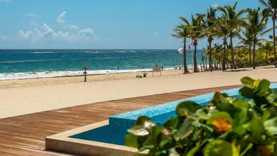 a view of the beach and the ocean from a resort at Luxury Gateaway Penthouse in front of Hard Rock in Punta Cana