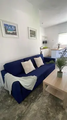 a blue couch in a living room with a table at Villa Mar En Dreams House - 4 Pax, 2 Min de La Playa in Las Galeras