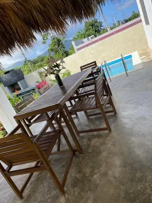 a wooden table and chairs on a patio at Villa Mar En Dreams House - 4 Pax, 2 Min de La Playa in Las Galeras