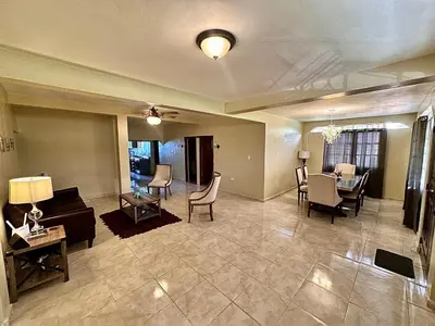 a living room with a couch and a table and chairs at Casa Vista Mar, Los Patos, Barahona - 4x4 or All Terrain Vehicle to Access Property in Los Patos